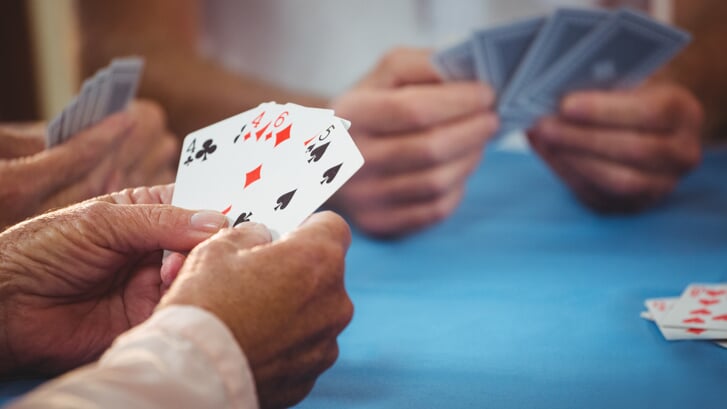 Retired people playing card in a retirement home