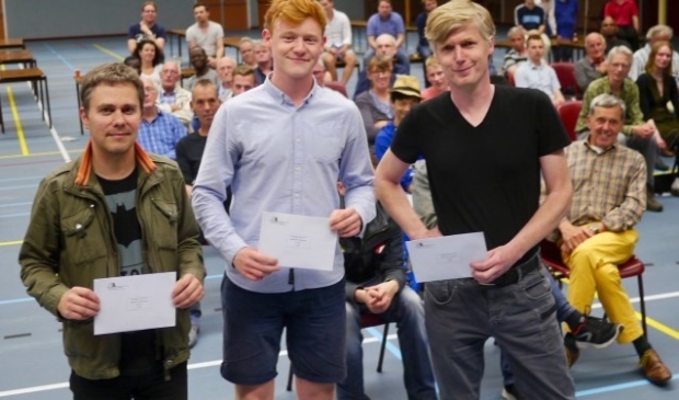 Geflankeerd door Aleksej Domchev (links) en Johan Krajenbrink koestert Jan Groenendijk met een gelukzalige glimlach de eerste prijs van 500 euro. Foto: Nijmegen Open