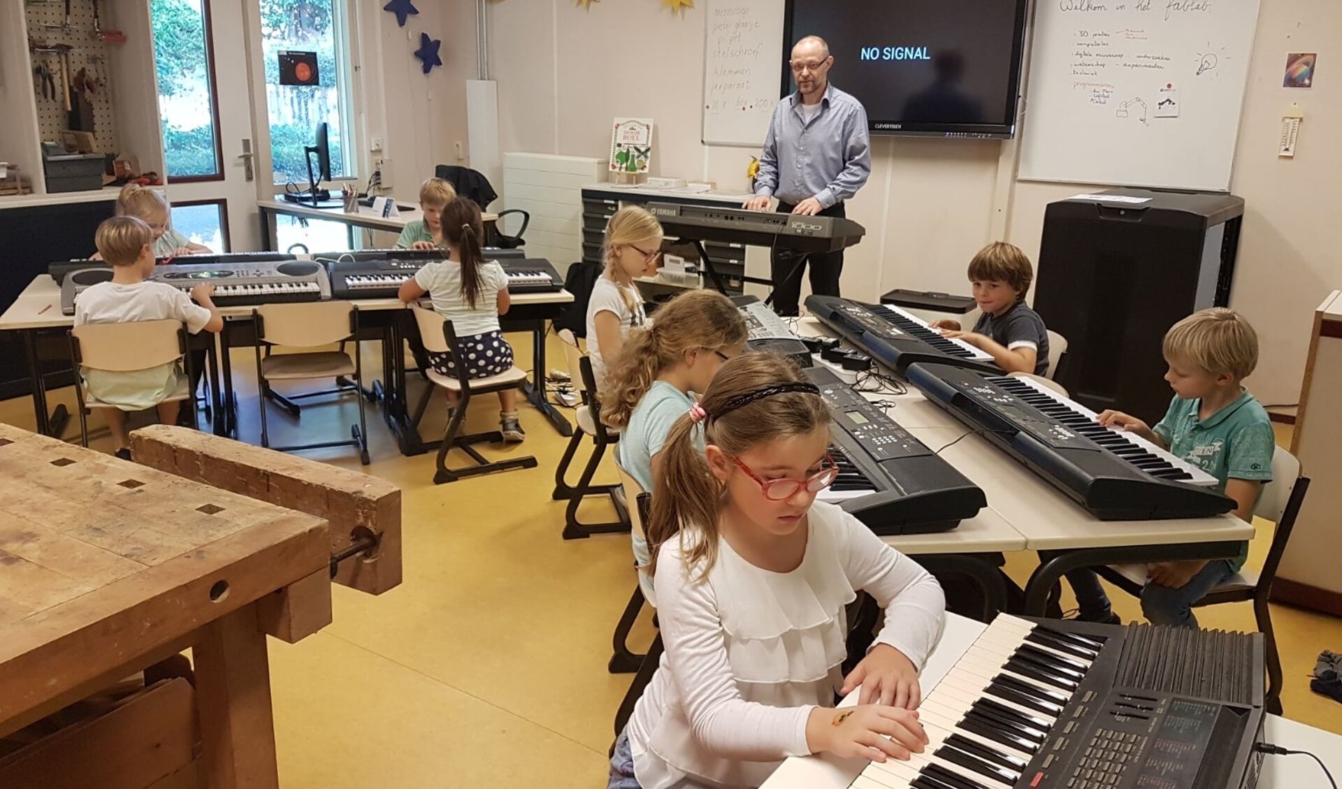 De kinderen tijdens een muziekles op school