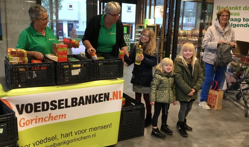 De dochters van Angela ‘t Lam geven de boodschappen aan vrijwilligers van de voedselbank