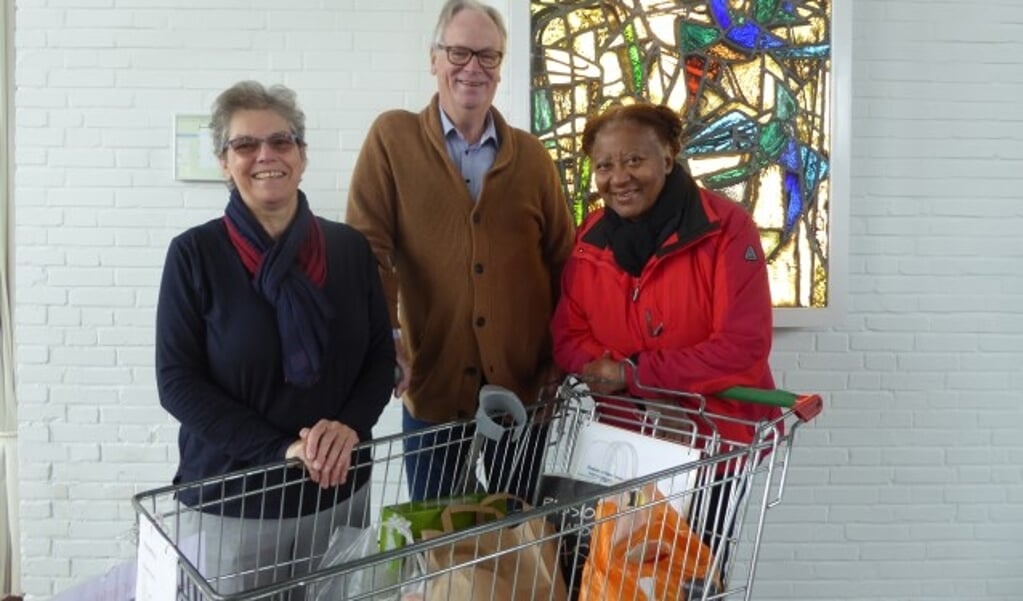Jannie van Doorn, Fedde Makkinga en Lucy Kortram bij de boodschappenkar voor de Voedselbank. (foto: Marnix ten Brinke)
