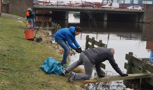Bij het opschonen van de Jan Gijzenkade moesten soms acrobatische toeren uitgehaald worden.