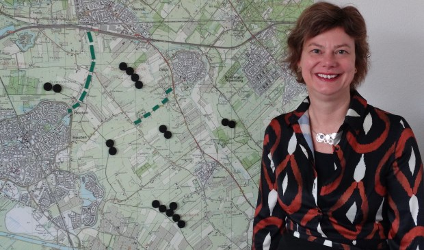 Wethouder Erika Spil (P21) bij de kaart met locaties: de zwarte cirkels staan voor het maximum aantal windmolens