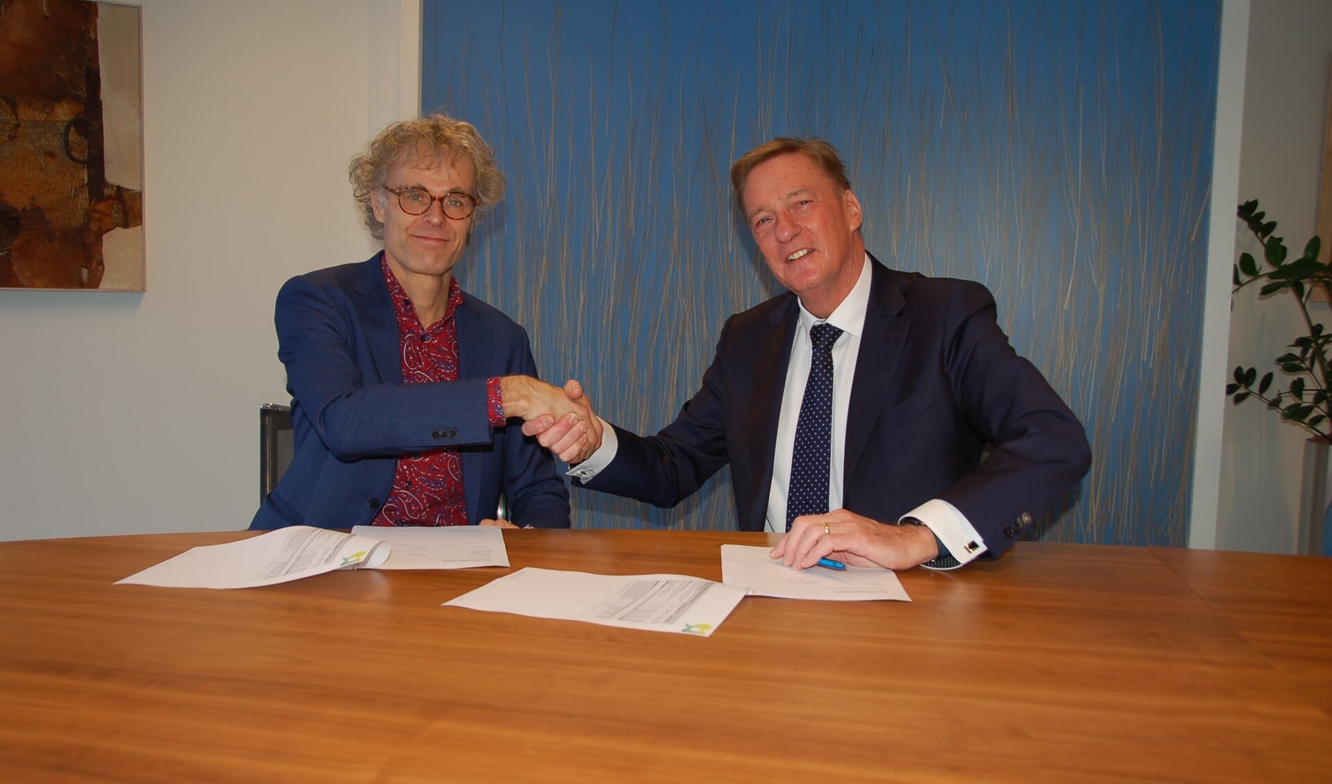 Evert Bartlema, directeur van !Woon en wethouder Rob Ellermeijer na ondertekening van het contract.