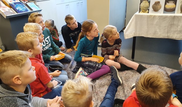 Kinderen luisteren geboeid naar verhalen over de Romeinse tijd
