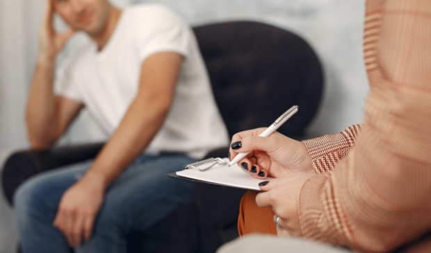 In the psychologist's office. Man and woman talking