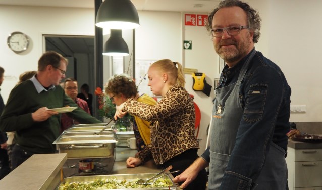 Kok Ron Kamping achter het vers bereide kerstbuffet voor bewoners van De Asschat en genodigden.