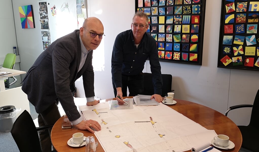 Wethouder Gerrit Boonzaaijer (links) en projectleider Kees van Zutphen buigen zich over de plannen voor de Koenestraat.