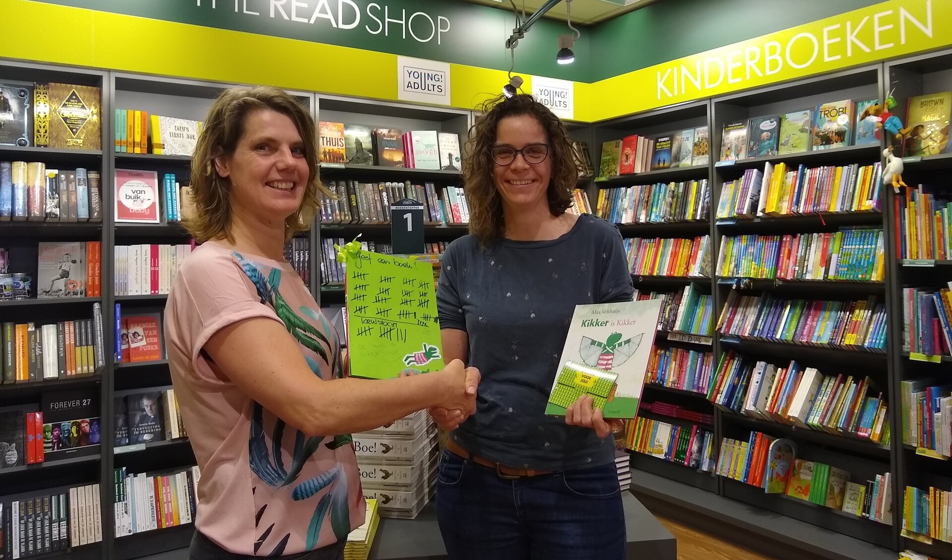 Petra Stam van The Readshop Doorn overhandigt de gedoneerde boeken en prentenboeken aan Femke Reijnen.