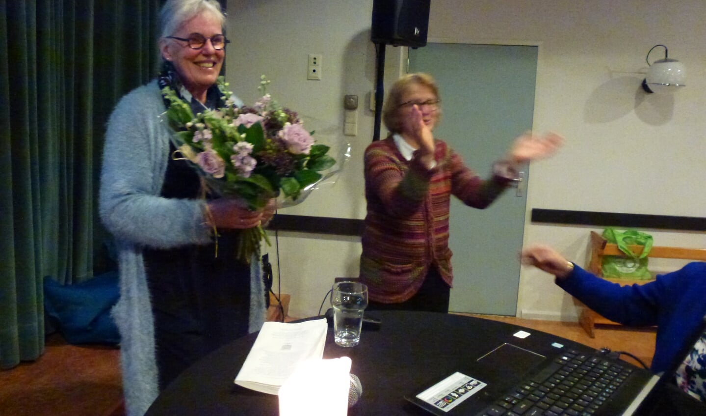 Mevr. Joke Kraal krijgt bloemen van voorzitter van Passage Nijkerk