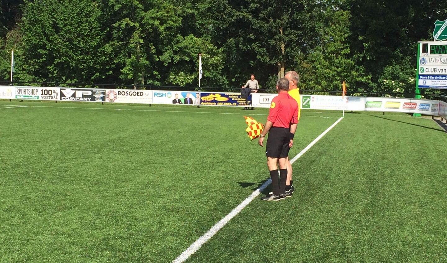 Scheidsrechter en assistent-scheidsrechter SP Teuge overleggen over wel of geen buitenspel.