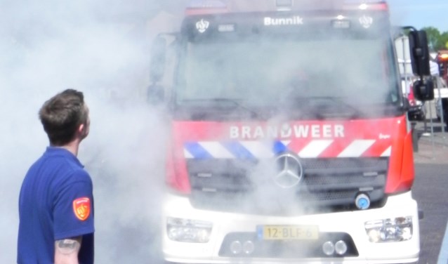 In een wolk van rook presenteerde de brandweer haar nieuwe wagen.