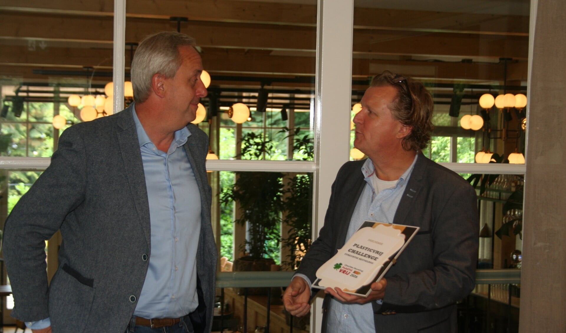 Wethouder Hans Waaldijk ontvangt het schildje van de PlasticVrij Challenge