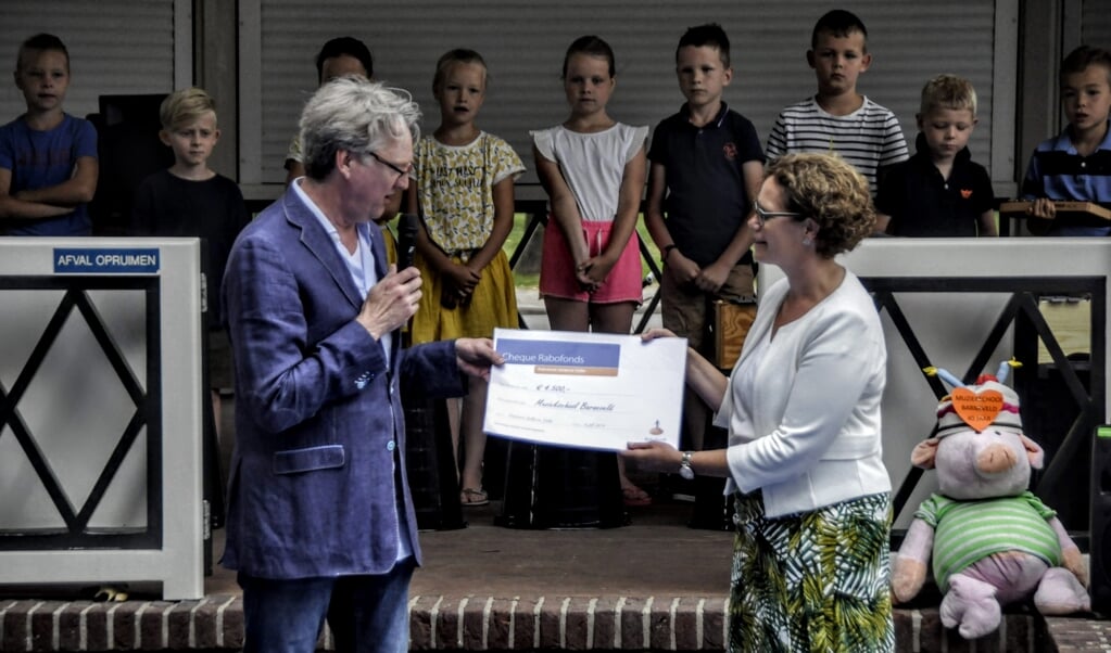 Directeur Ferdi Schukking (links) van Muziekschool Barneveld ontvangt uit handen van Claudia van den Brink van het Rabofonds een cheque voor de nieuwe talentklas.