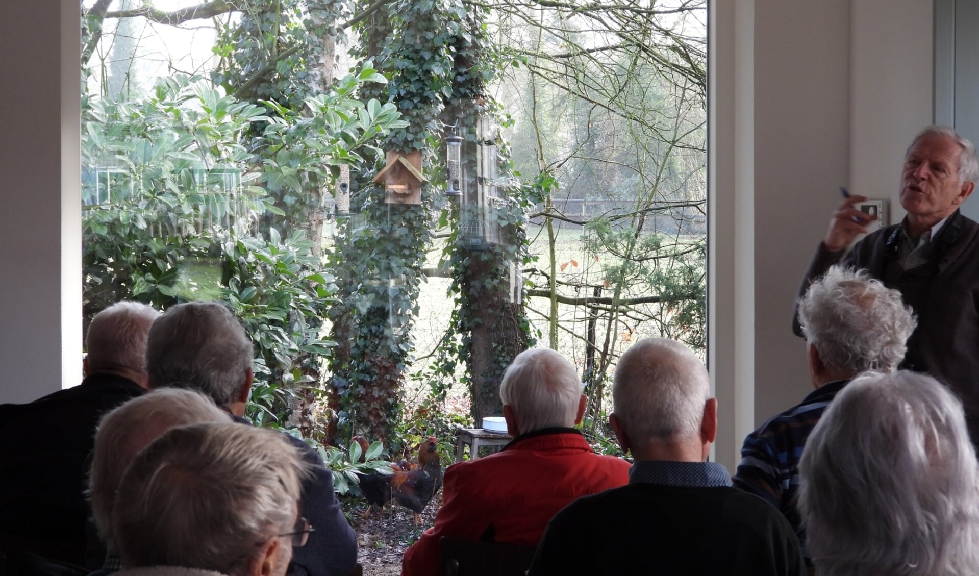 De vogeltellers luisteren in het Landhuus naar verhalen van Jan van den Heuvel.