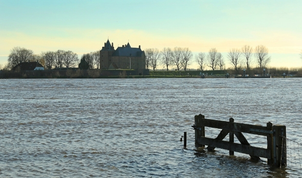 Water en verzonken land met een hek wat nog boven water te zien is.