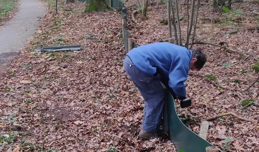 Vrijwilliger vervangt paaltjes van het  paddenscherm Zanderij in Maarn
