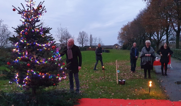 Burgemeester Isabella bij de zojuist aangestoken boom. Hangt een hanger in de boom ter herinnering aan zijn ouders.