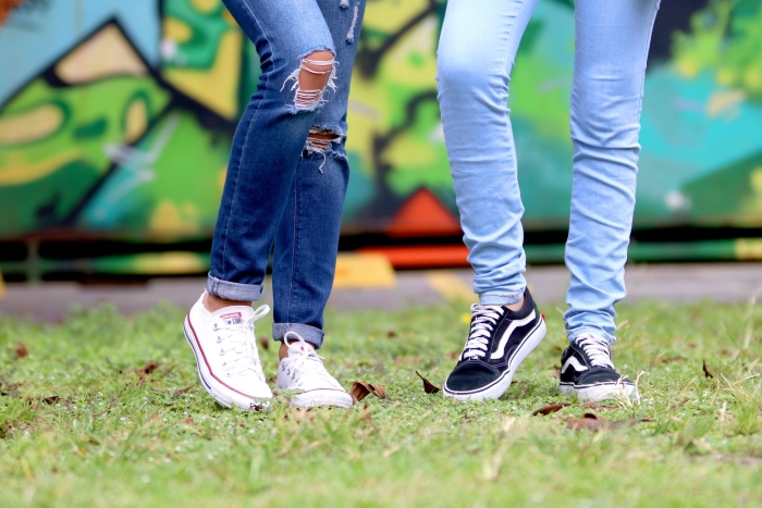 Persons wearing white and black lowtop sneakers