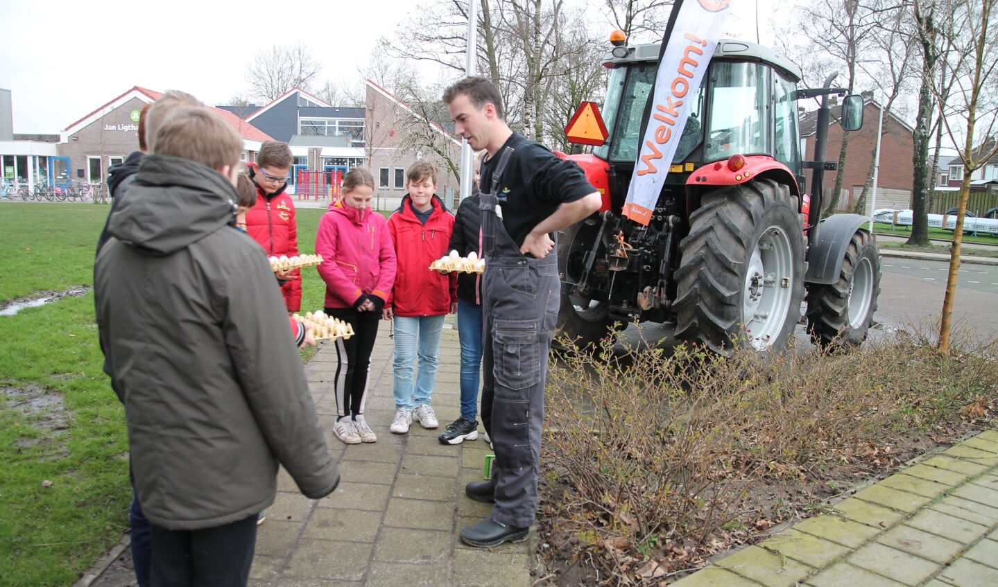 Van Ginkel met een groep kinderen bij zijn trekker.