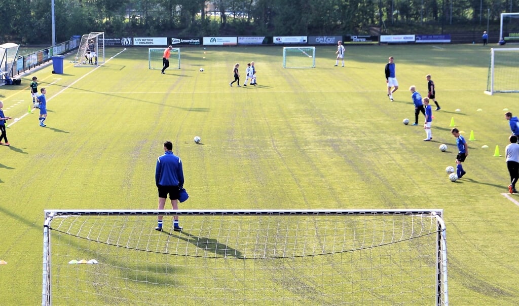 Overzichtsbeeld van de voetbaltraining bij Scherpenzeel, uiteraard met oefenvormen waarbij anderhalve meter afstand werd gehouden. 