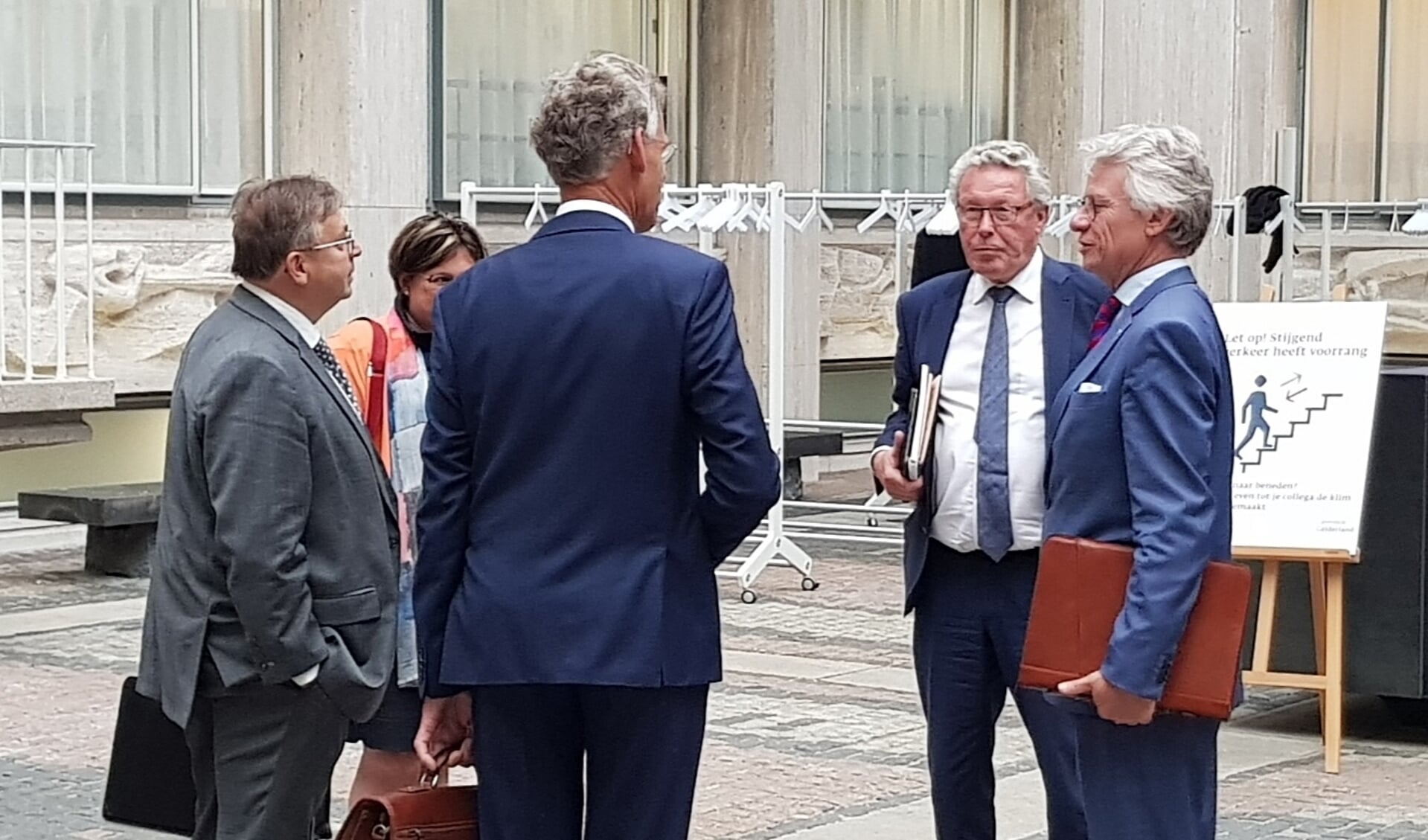 Commissaris van de koining John Berends en gedeputeerde Markink in gesprek met onder anderen de Scherpenzeelse wethouders Gerard van Deelen en Izaäk van Ekeren. 