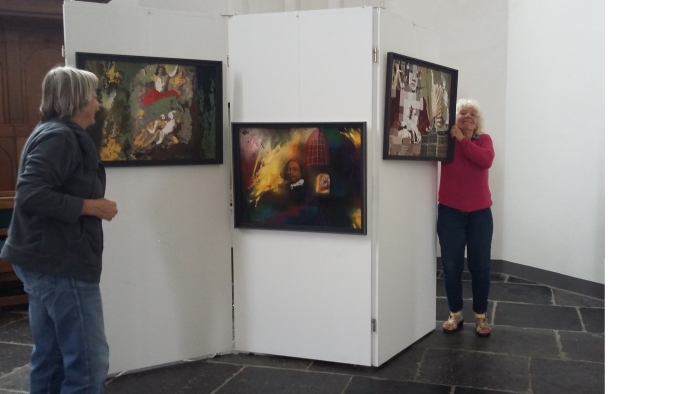 Marjolein Tönis in de weer met het goed ophangen van haar kunst.
