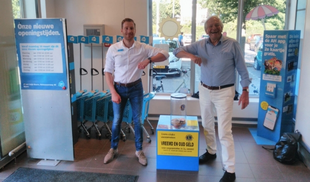 Albert Heijn manager Albert Buijs samen met Herman Olde Heuvelt van Lionsclub Eemland bij de Lions geld verzamelzuil.