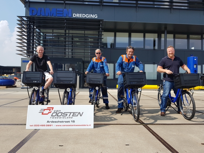 De bedrijfsfietsen worden overhandigd aan een enthousiast Damen Dredging team