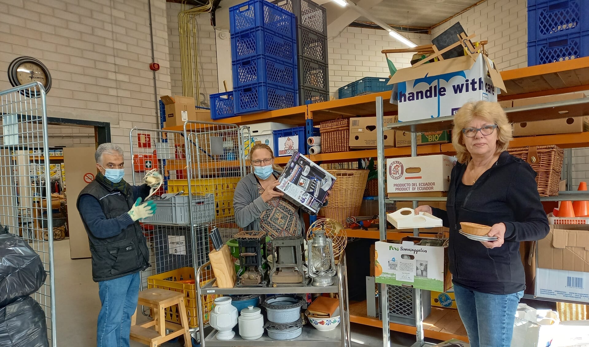 Bedrijfleidster Saskia van Diemen te midden van twee vaste krachten van Kringloop Gorinchem. 