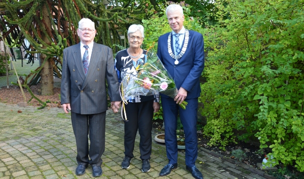 <p>Het 60-jarig bruidspaar met loco-burgemeester Hans Buijtelaar</p>