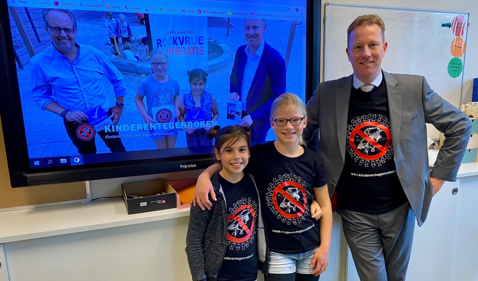 Ambassadeurs Rookvrije Generatie Saskia en Anna dragen, samen met wethouder Jeugd Frank Berkhout, het T-shirt dat ze zelf ontworpen hebben. 