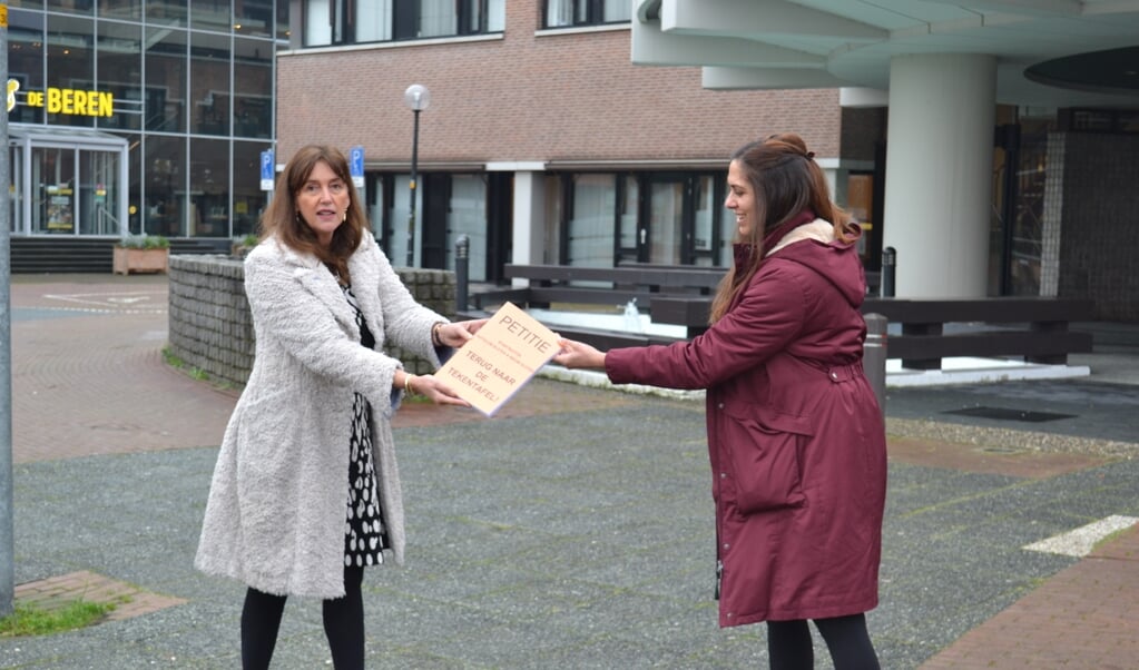 Janita Kieft van de belangengroep (rechts) overhandigt de petitie met onder andere 900 handtekeningen uit Badhoevedorp. 