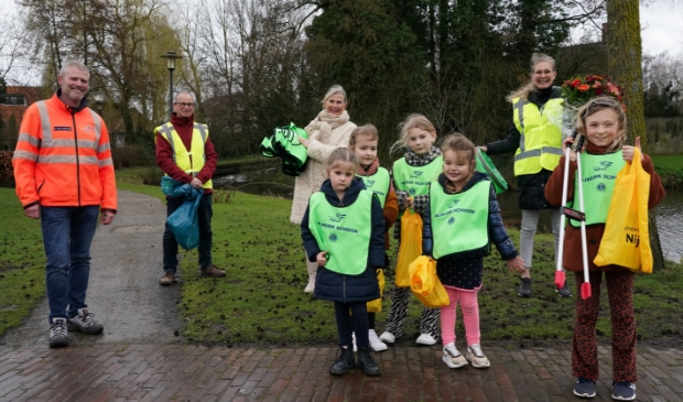 <p>Ronald van t Hazeveld namens de gemeente Nijkerk en voorzitter Anja Vedder van de Lions Nijkerk schenken zestig kinderveiligheidshesjes.</p>