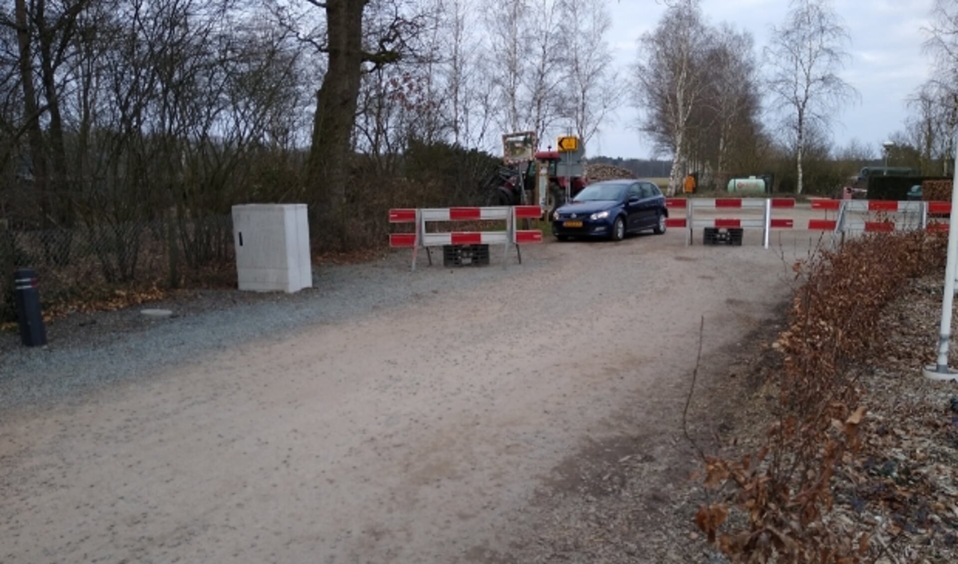 Een automobilist wurmt zich tussen de hekken door op camping De Lindenhof in Wolfheze. Foto: Kees Jansen