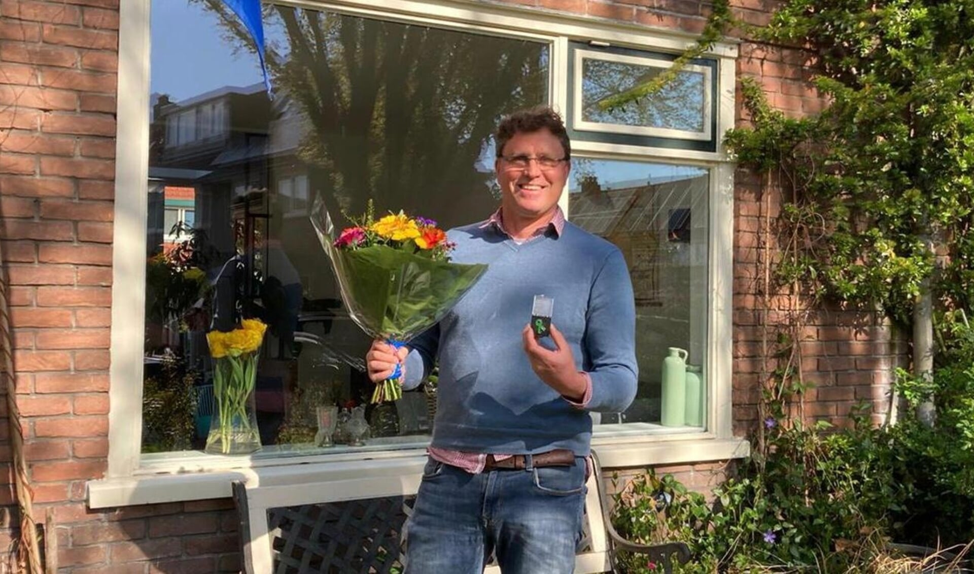 Fokke de Jong ontvangt een lintje en bloemen van Groenlinks Amersfoort.