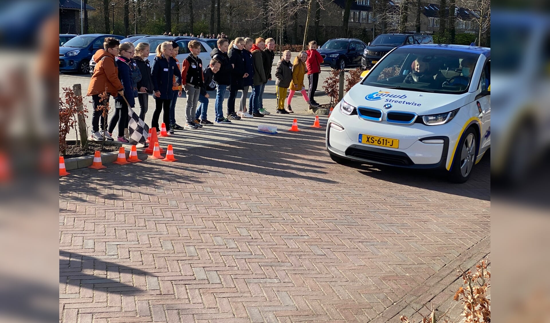 De geblokte vlag is omlaag gegaan en dus wordt er ineens geremd door de testauto van Streetwise.