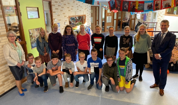 <p>Alle leerlingen die mee hebben geholpen met het planten van de bloemen samen met voorzitter van Oranje Trouw Bertie den Breejen en burgemeester Dirk Heijkoop</p>