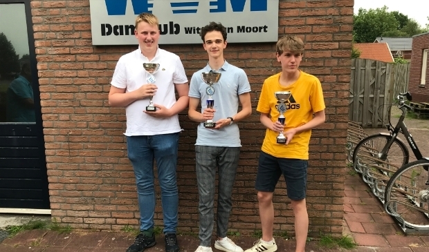 <p>Machiel Weistra met de kampioenbeker, geflankeerde door de nummers twee en drie Tom Rinner (links) en Simon Harmsma. Foto: Mariëtte Weistra </p>