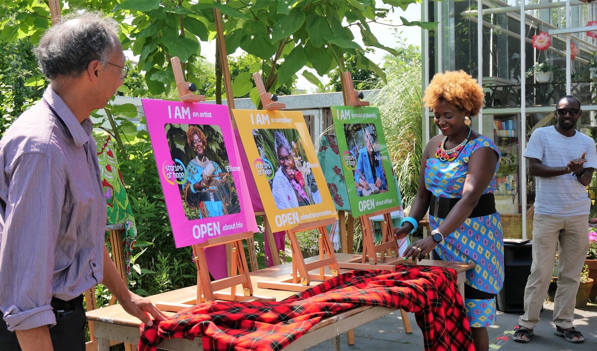 Het projectteam, Eliane Nininahazwe en Paul Liklikuwata, onthult de portretten van deelnemers aan 'Stories of Hope'