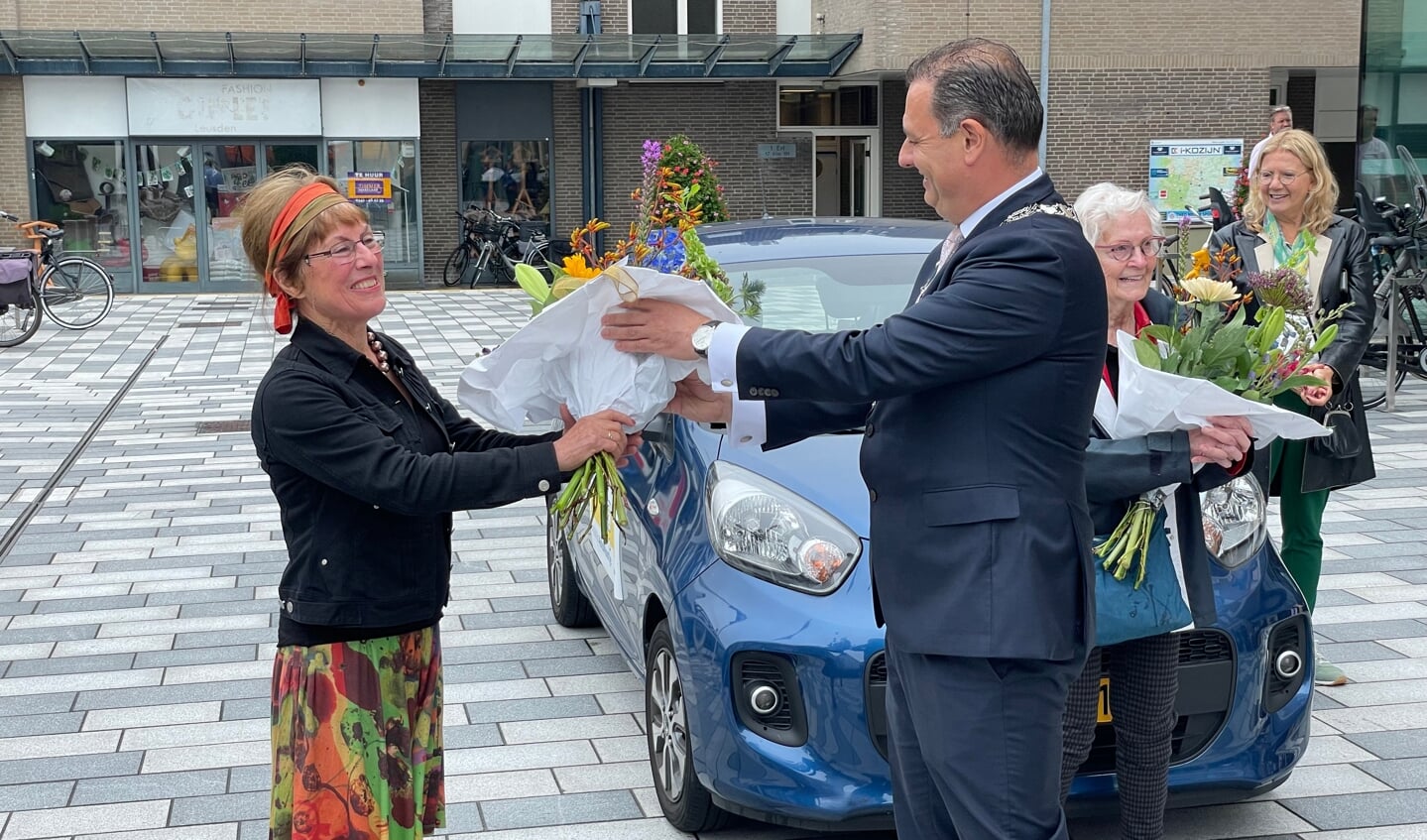 Chauffeur José krijgt een bloemetje van de burgemeester.