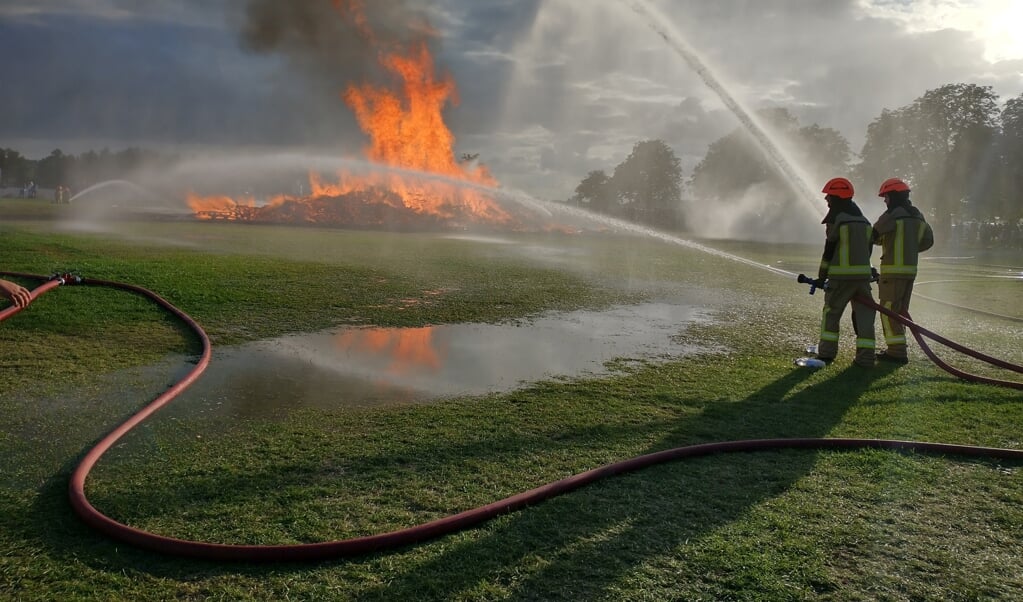 Brandweermannen houden de verbranding van Timmerdorp Gorinchem onder controle.