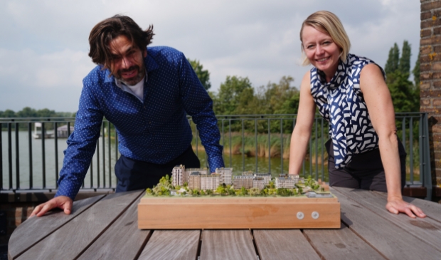 Stadsbouwer Marijn Schenk en wethouder Floor Gordon met een maquette van de wijk Olympiade.