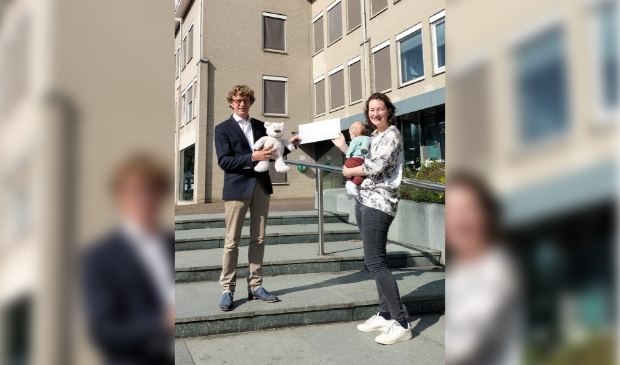 <p>Jorine Rabius ontvangt uit handen van wethouder Jan Overweg een tegoedbon voor de cursus OudersInc. De knuffelbeer is voor baby Bram. </p>