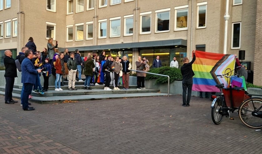 Een van de twee vlaggen wordt gehesen met drie dansers van Shine