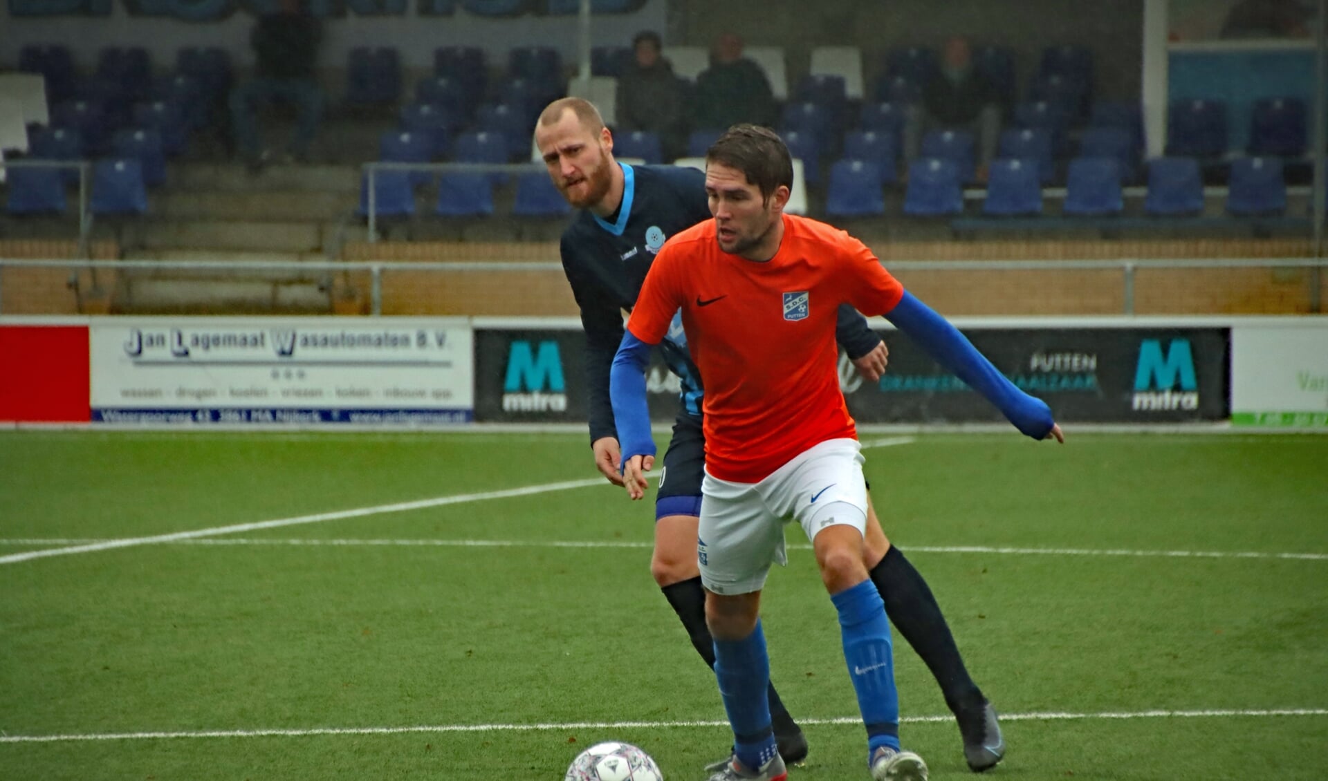 SDC Putten-middenvelder Vincent ter Burg (oranje shirt) in duel met Eef van Riel van v.v. Scherpenzeel.
