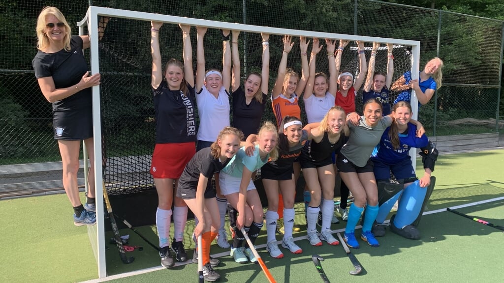 Shinty Meisjes B met uiterst links coach Chantal Klijnhout en uiterst rechts aanvoerder Lotte Masseling.