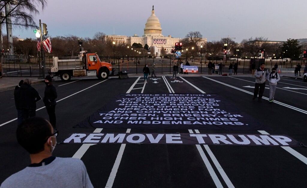 2021-01-13 18:38:44 epa08936278 A large banner with the impeachment clause of the US constitution seen near the US Capitol in during today’s impeachment of US President Donald J. Trump by the US House of Representatives, kiss in Washington, DC, USA, 13 January 2021. The House impeached the president a second time for incitement of insurrection following the attack on the Capitol on 06 January as lawmakers worked to certify Joe Biden as the next President of the United States.  EPA/JUSTIN LANE