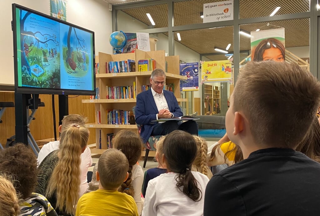 Wethouder Marco Verloop leest de kinderen van Achtbaan voor op het leerplein.