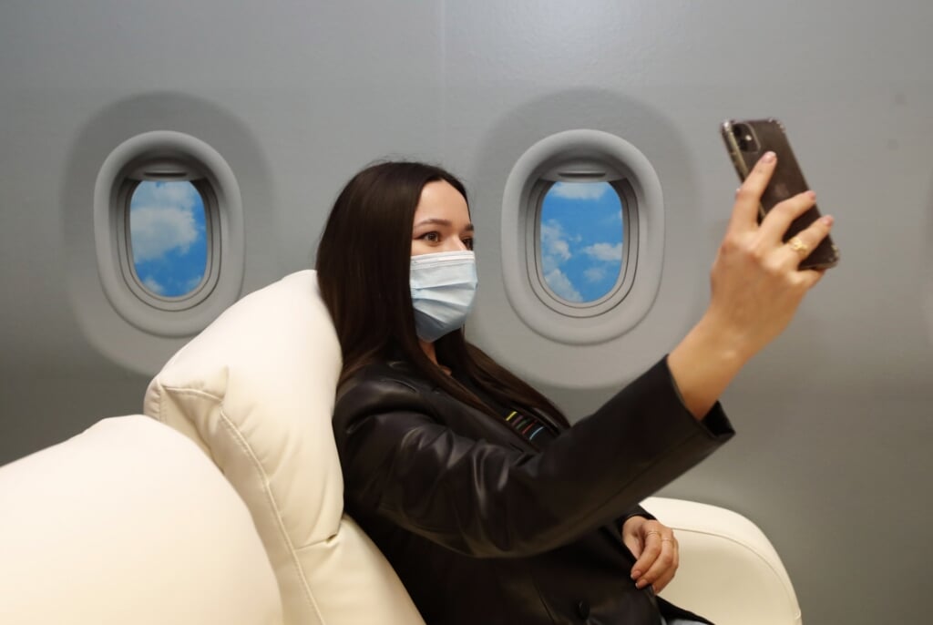 2021-04-21 15:50:09 epa09154178 A model poses for a selfie in scenery resembling a luxurious interior of a busines airplane at a special Selfieroom in Zagreb, Croatia, 21 April 2021 (issued 23 April 2021). Zagreb, and the whole of Croatia, now has its first 'Selfieroom', a  unique place for special photo experiences, where customers can enjoy in making photos, mainly selfies, in specially arranged sceneries, which they can then publish in social media like Instagram, Facebook, Tik Tok and others. Zagreb's 'Selfieroom' for now offers eight different sceneries, including a London telephone booth, airplane seats, a romantic place for lovers in a garden full of flowers, a bathtub filled with money, and others. Due to the COVID-19 prevention measures, the maximum group number of visitors, may it be relatives, friends or others, is limited to seven at a time, and the entrance is 50 kunas (about 7 euros) for each.  EPA/ANTONIO BAT